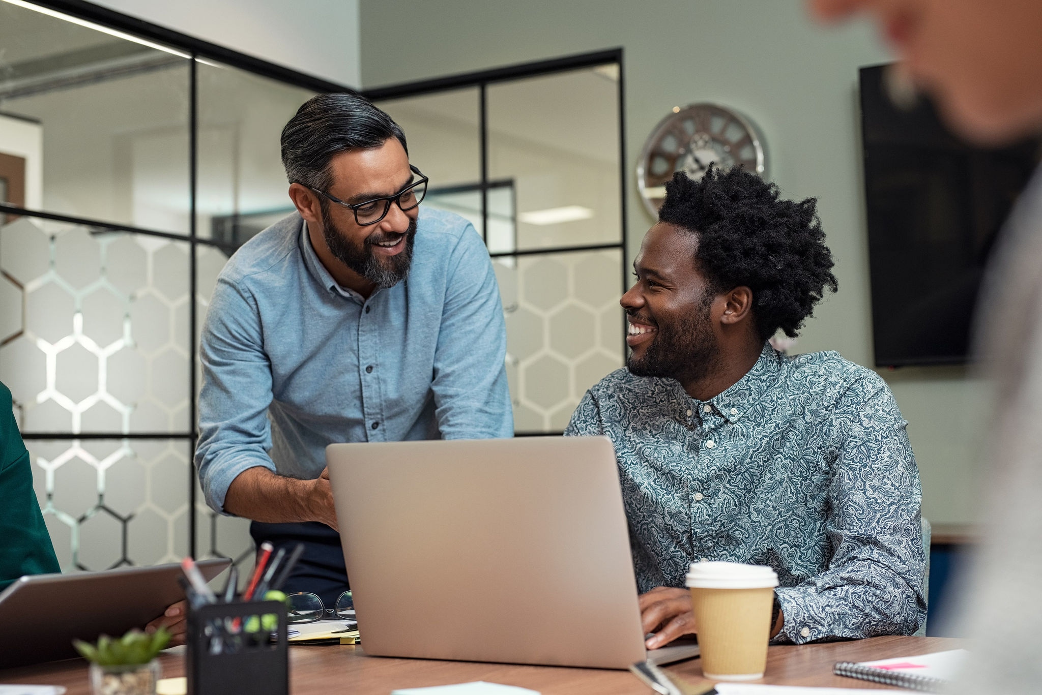 People having a discussion with a laptop in a meeting room