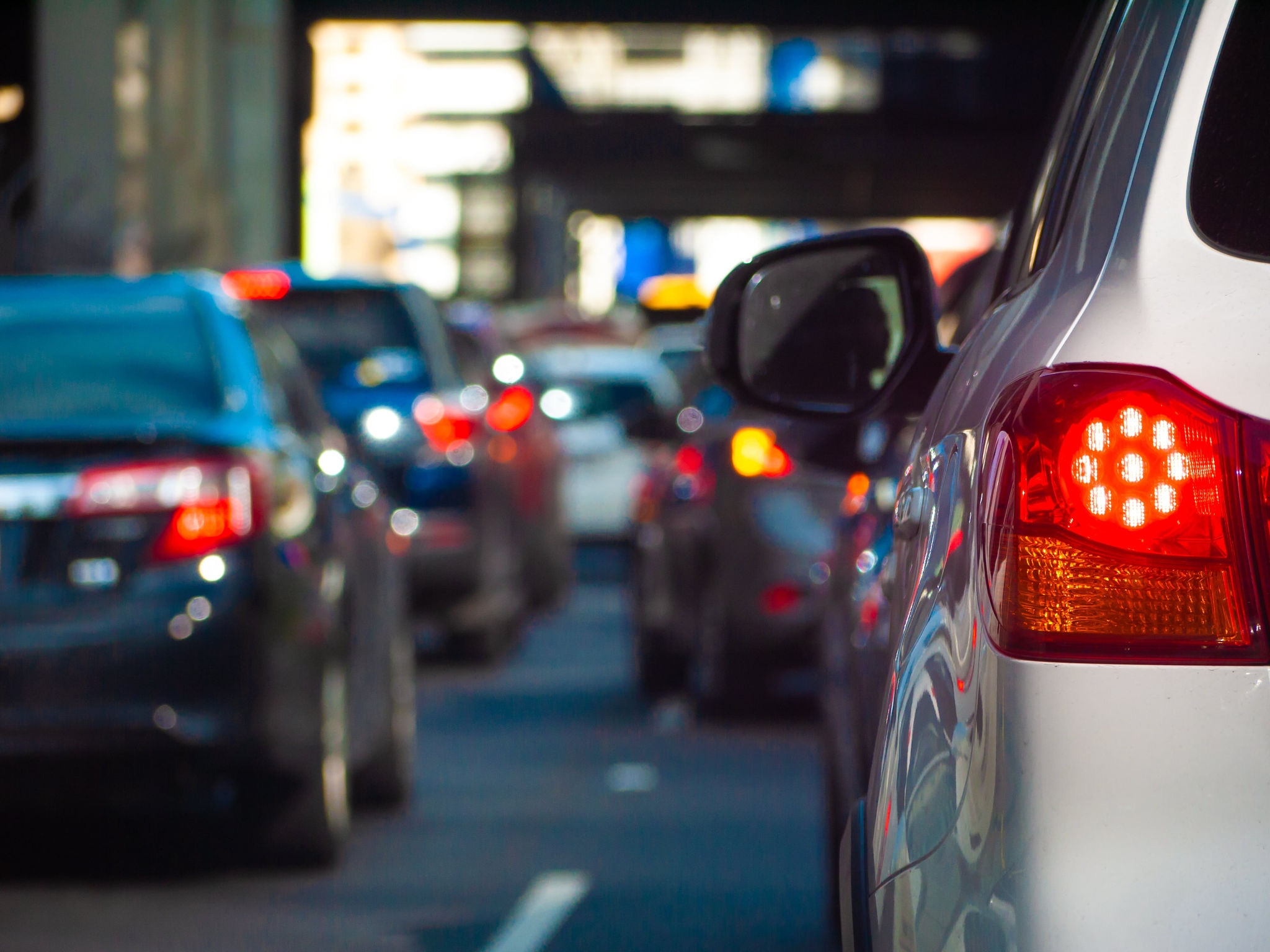 White car in traffic with brake light on