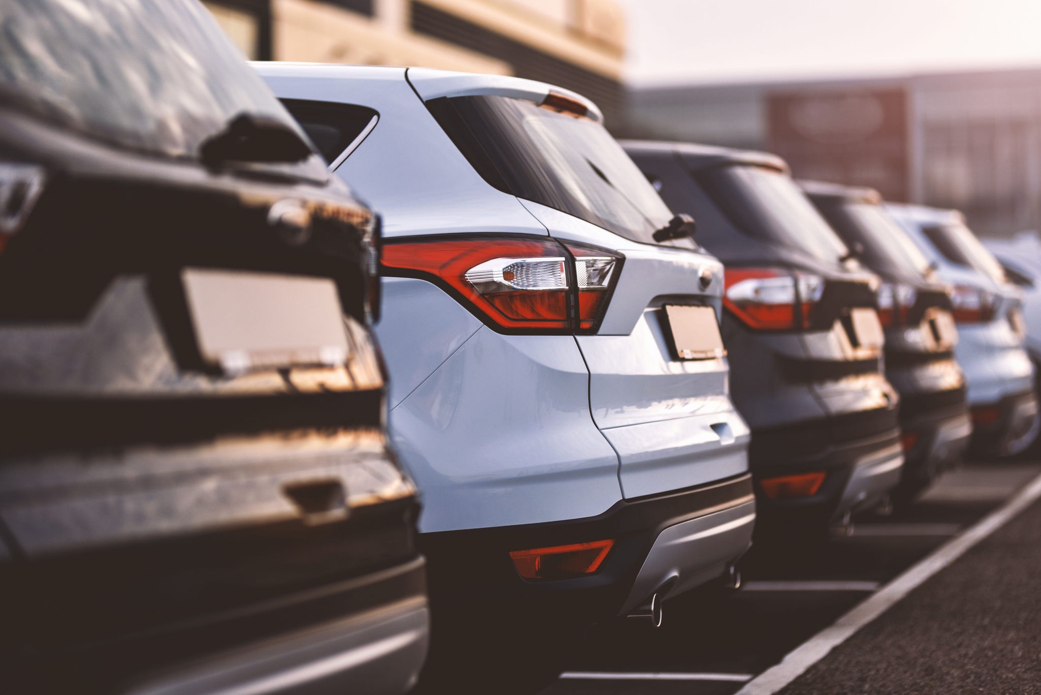 Black and white cars parked neatly in a parking lot