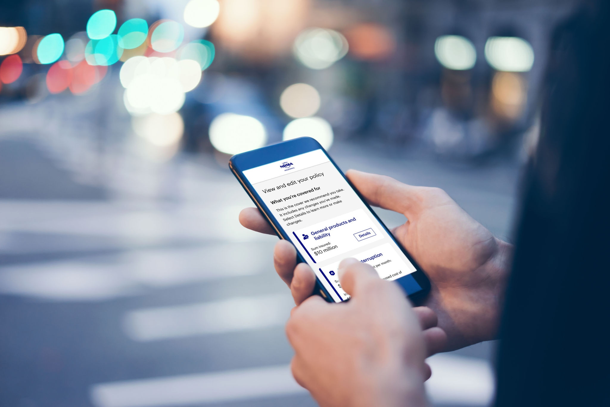 Person holding smart phone showing the NRMA App with view and edit screen