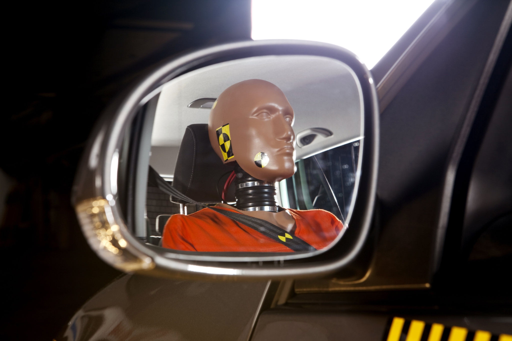 Close up of a crash test dummy sitting in a car